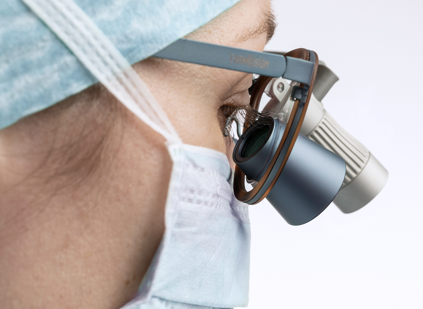 Female surgeon wearing loupes with surgical headlight attached Total LED
